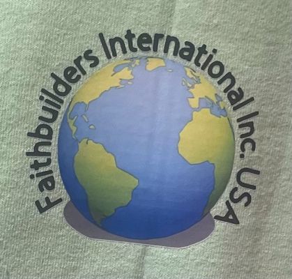 A joyful child holding a handcrafted football, standing in front of a community center.