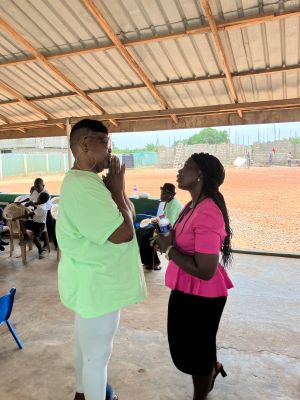 Children enjoying a newly built water station in a community project celebrating partnership and progress.