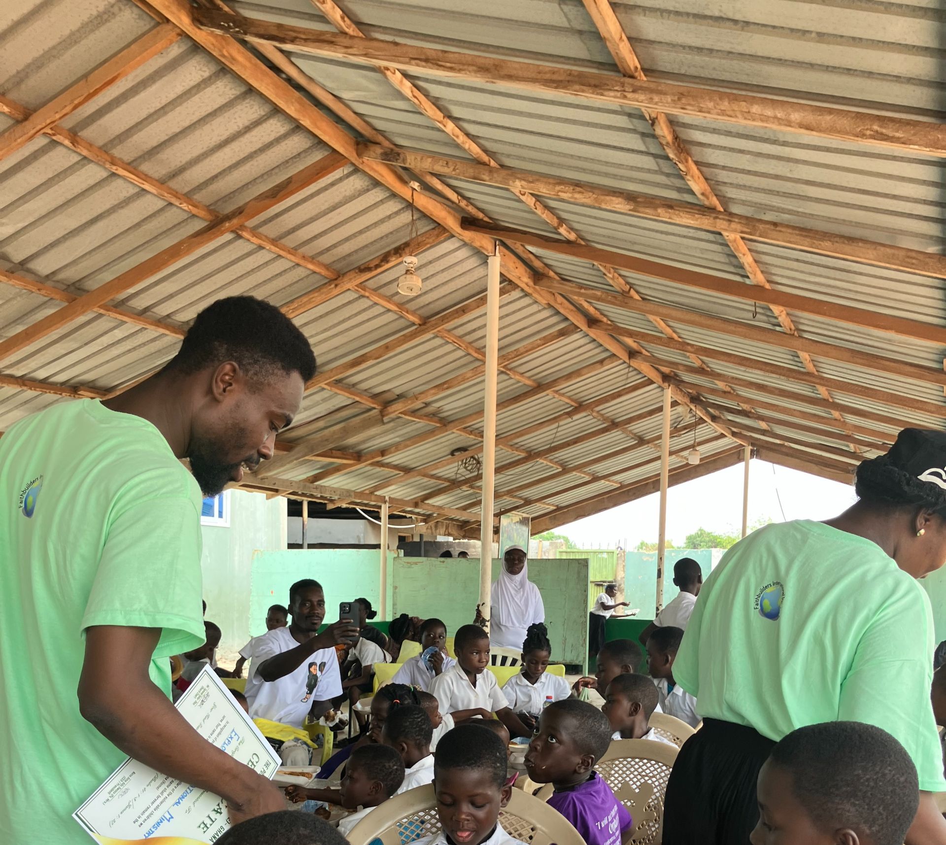 FaithBuilder Elders of Exploit Outreach feeding children at The Potter's Village known as an orphanage in Dodowa Ghana